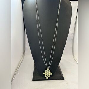 Lia Sophia long necklace pastel green cross pendant on a silver-tone chain.